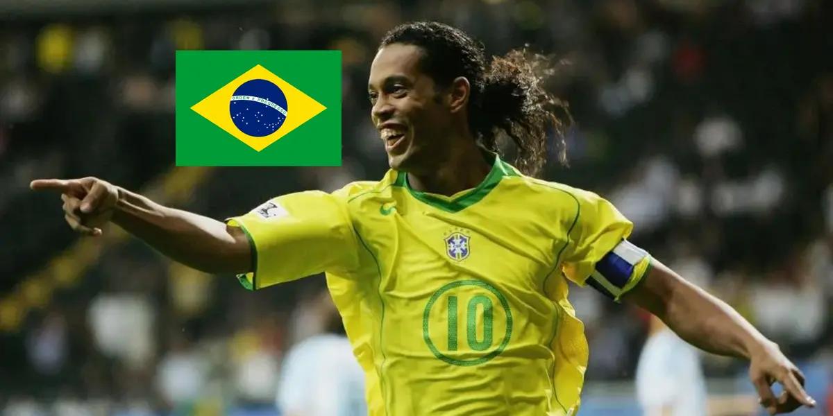 Ronaldinho smiles and points while wearing the Brazil jersey; the Brazil flag is next to him.