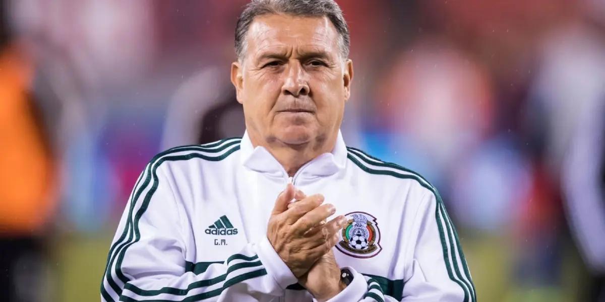 Tata Martino claps while wearing the Mexico sweater.