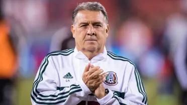 Tata Martino claps while wearing the Mexico sweater.