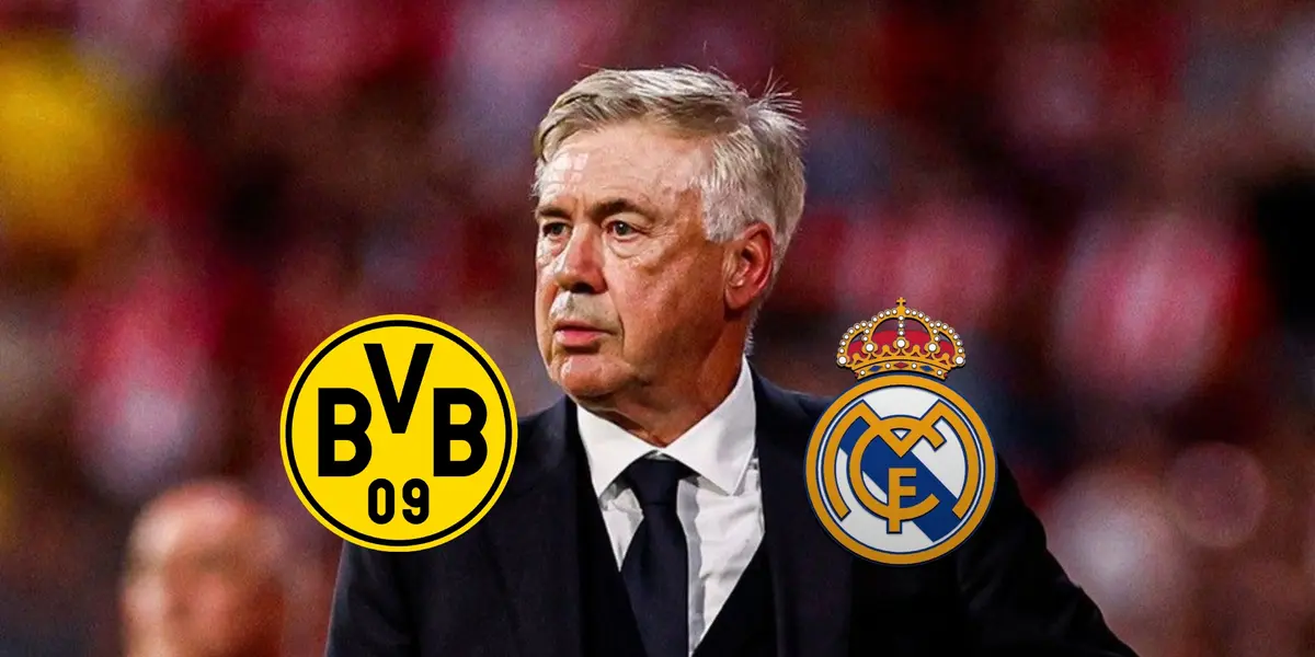 Carlo Ancelotti looks onto the pitch as the Borussia Dortmund and Real Madrid badges are below him.