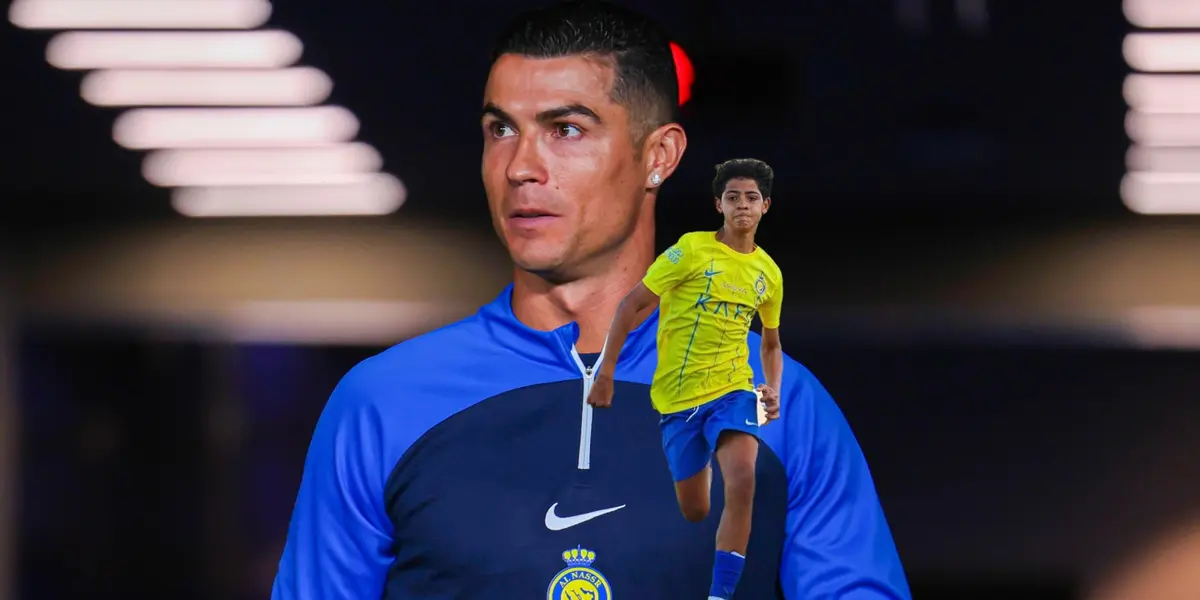 Cristiano Ronaldo looks out onto the pitch while Cristiano Ronaldo Jr. runs for the ball.