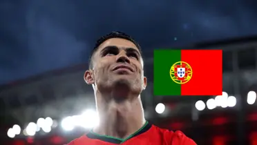 Cristiano Ronaldo smiles as he looks up wears the Portugal jersey and the Portugal flag is next to him. (Source: Al Nassr Zone X)