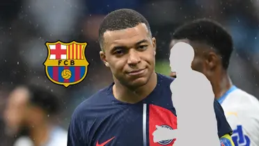 Kylian Mbappé has a slight grin while the FC Barcelona badeg and a mystery player is next to him.