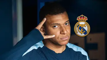 Kylian Mbappé looks at the camera while where the France training kit and the Real Madrid badge is next to him.