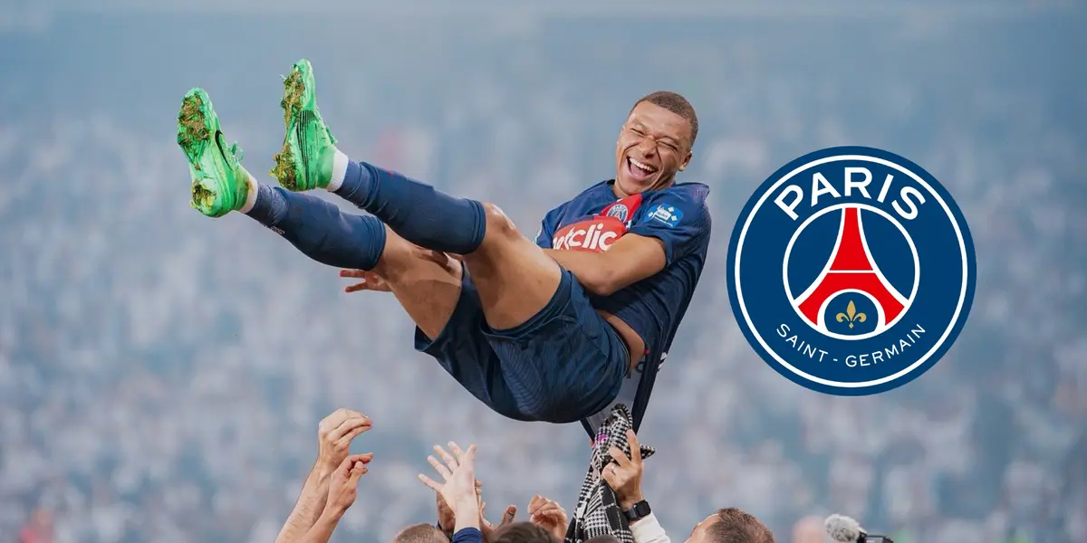 Kylian Mbappé smiles in the air as he is thrown by his PSG teammates; the PSG badge is next to him.