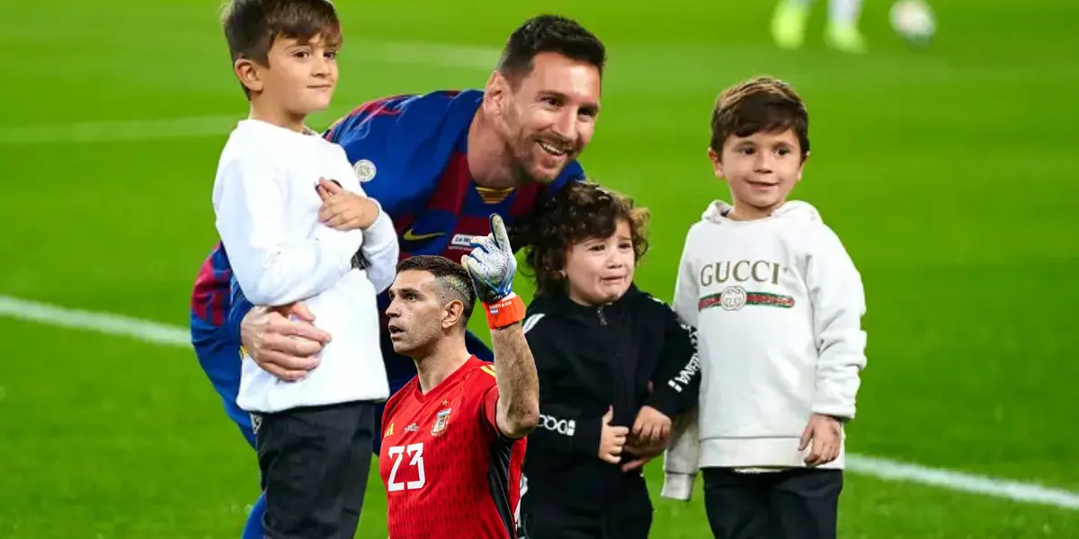 Lionel Messi poses for a picture with his children while Emiliano Martinez points up while wearing the Argentina national team goalkeeper kit.