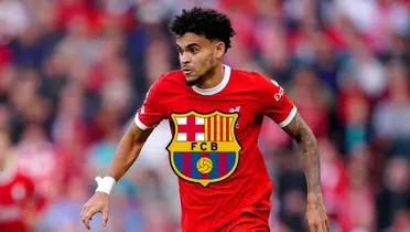 Luis Diaz is focused while wearing the Liverpool jersey and the FC Barcelona logo is below him.