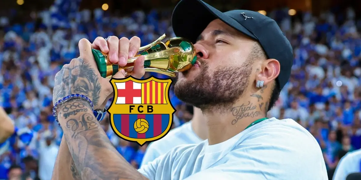 Neymar Jr kisses a mini replica of the King's Cup trophy while the FC Barcelona badge is next to him.