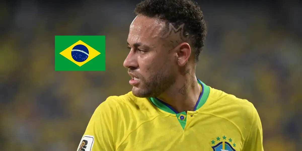 Neymar Jr. looks to his right as he wears the Brazil jersey and the Brazil flag is to the side of him. (Source: Getty Images)