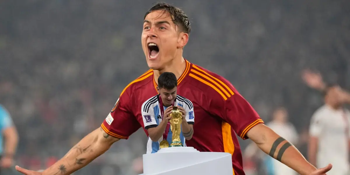 Paulo Dybala celebrates a goal with AS Roma while he also looks at the World Cup while wearing the Argentina jersey. (Source: Associated Press, Getty Images)