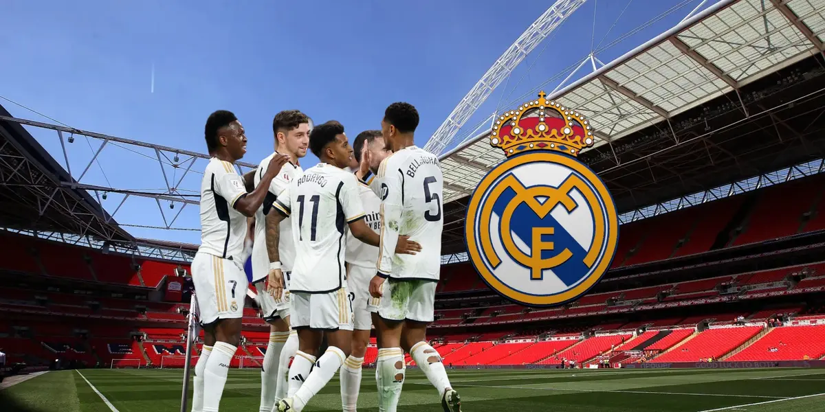 The Real Madrid team celebrate together while the Real Madrid badge is next to them; the background is Wembley Stadium.