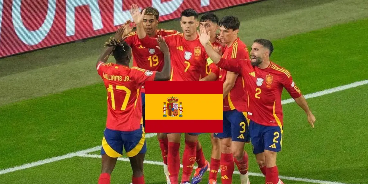 The Spanish national team celebrate a goal together while the Spanish flag is in the middle. (Source: AP Photo)