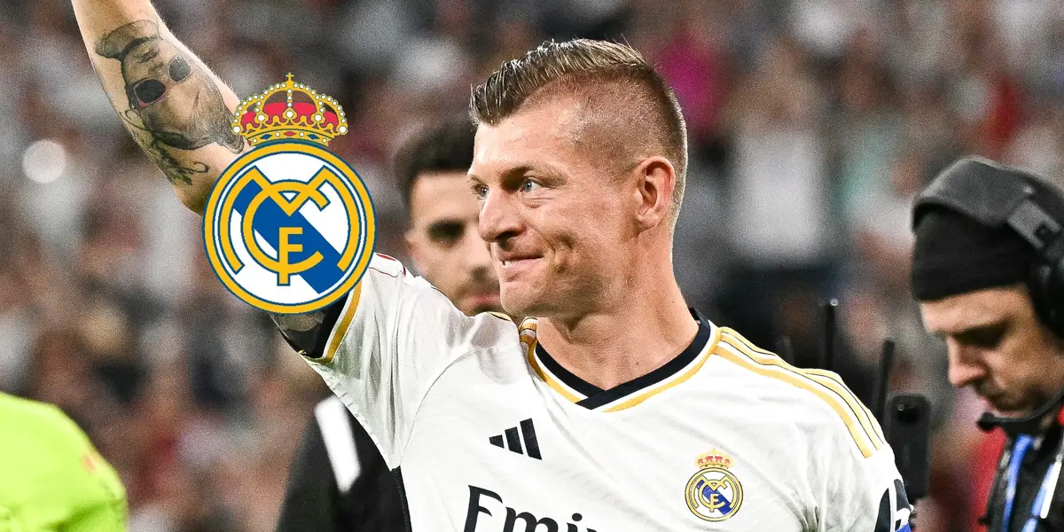 Toni Kroos smiles while wearing the Real Madrid jersey and the Real Madrid badge is next to him.