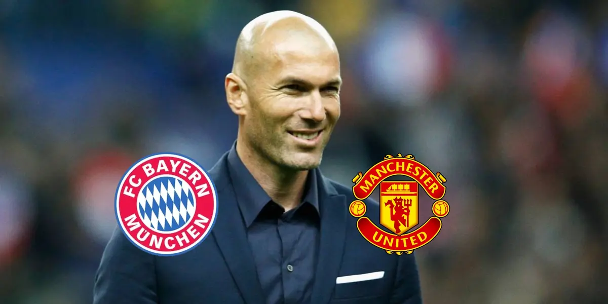 Zinedine Zidane smiles wearing a black suit with the logos of Bayern Munich and Manchester United next to him